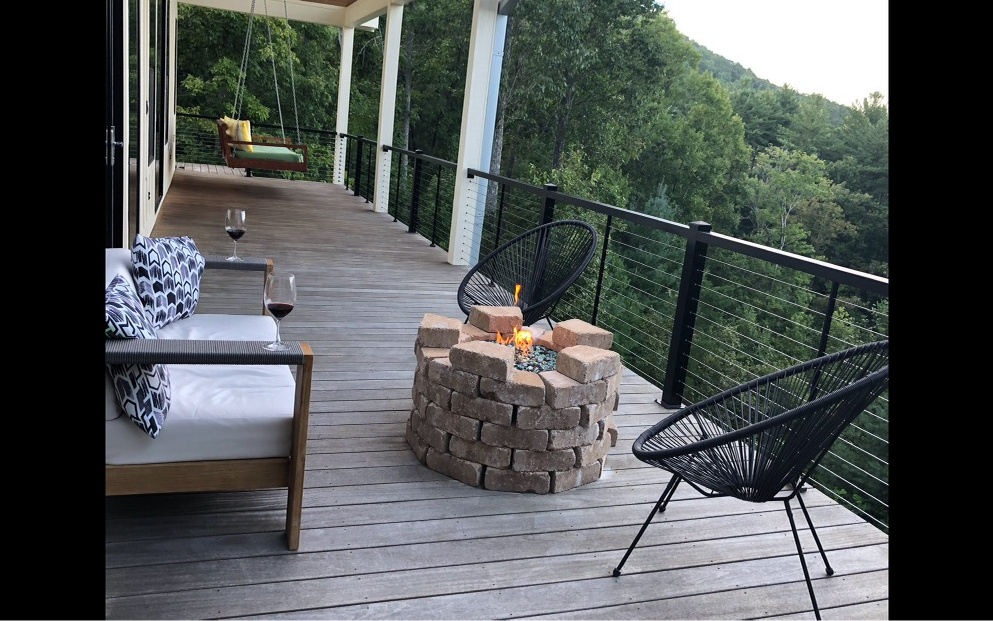 740 Chestnut Mountain Road Blairsville, GA 30512 - Photo 35 of 75 a view of a balcony with two chairs and a potted plant