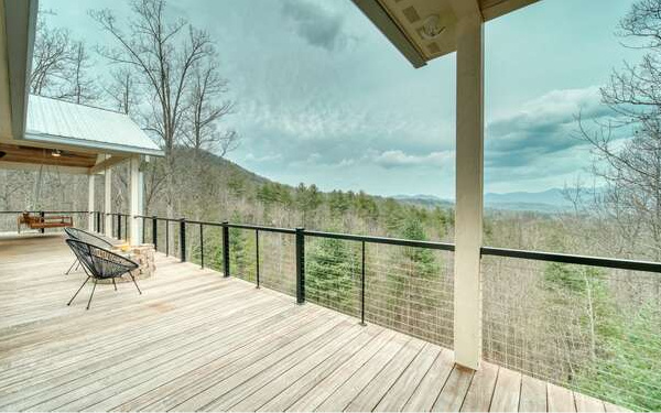 740 Chestnut Mountain Road Blairsville, GA 30512 - Photo 37 of 75 a view of balcony with two chairs and wooden floor