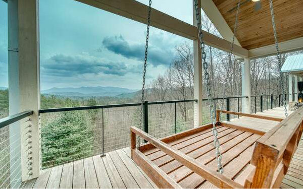 740 Chestnut Mountain Road Blairsville, GA 30512 - Photo 44 of 75 a view of a balcony with wooden floor and outdoor seating