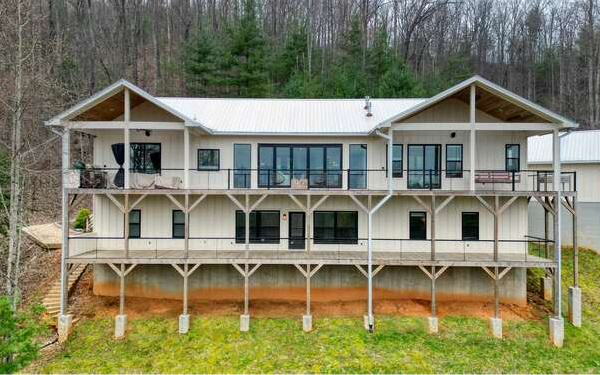 740 Chestnut Mountain Road Blairsville, GA 30512 - Photo 5 of 75 a view of a house with pool lawn chairs and a yard