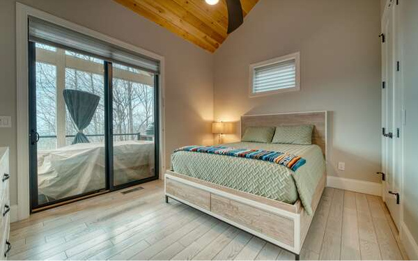 740 Chestnut Mountain Road Blairsville, GA 30512 - Photo 57 of 75 a bedroom with a bed and a mirror