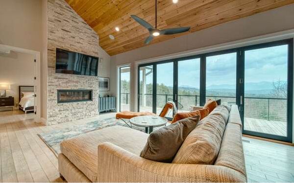 740 Chestnut Mountain Road Blairsville, GA 30512 - Photo 10 of 75 a living room with furniture large windows and a fireplace
