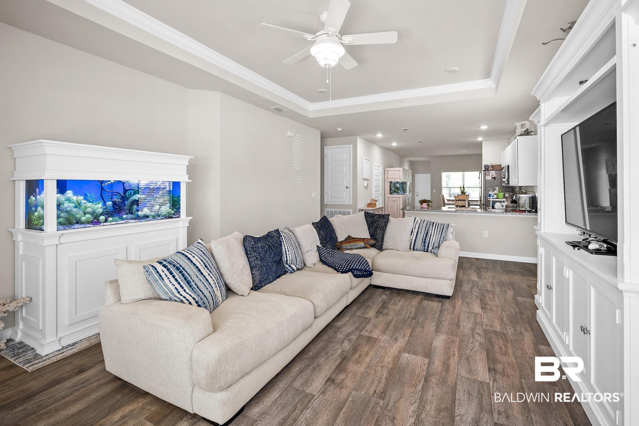 23997 Veranda Circle Elberta, AL 36530 - Photo 5 of 28 Spacious living area featuring wood-finish flooring, a tray ceiling with a ceiling fan, and recessed lighting