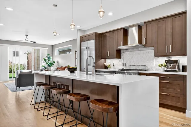 a kitchen with a table chairs refrigerator and cabinets