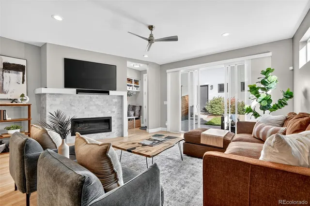 a living room with furniture a fireplace and a flat screen tv
