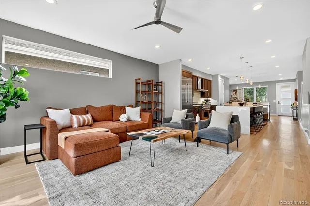 a living room with furniture and wooden floor