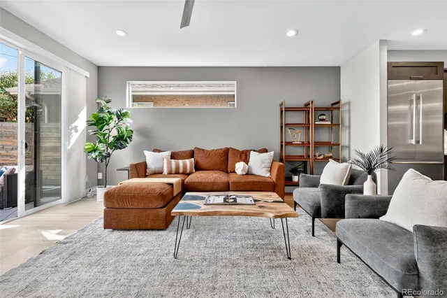 a living room with furniture and a potted plant