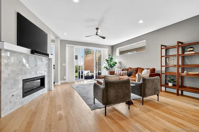 a living room with furniture flat screen tv and a fireplace