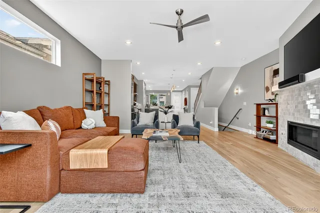 a living room with furniture kitchen view and a flat screen tv