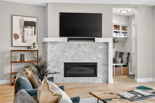 a living room with furniture fireplace and flat screen tv