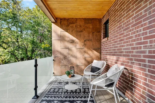 a balcony with table and chairs
