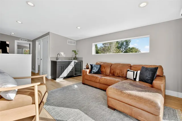 a living room with furniture with kitchen view