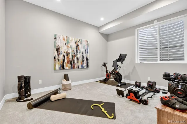 a room with gym equipment and lots of equipment