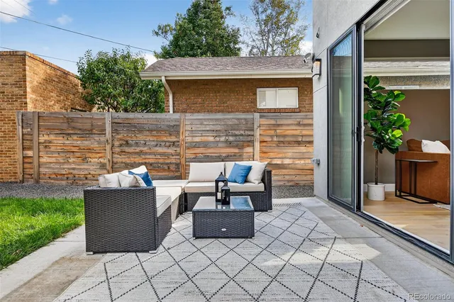 a view of a patio with couple of chairs and a fire pit