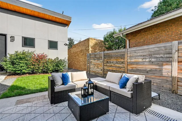 a view of a patio with couches and a table and chairs with garden view