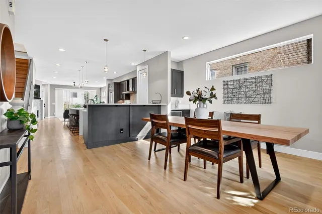 a dining room with furniture and wooden floor