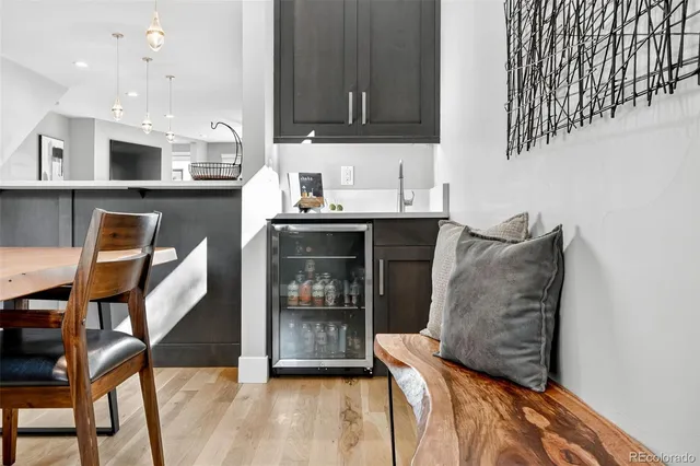 a kitchen with stainless steel appliances kitchen island granite countertop a table and chairs in it
