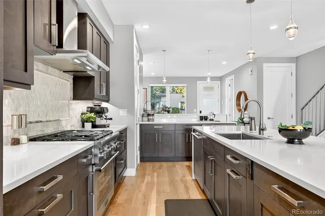 a kitchen with a sink stove and cabinets