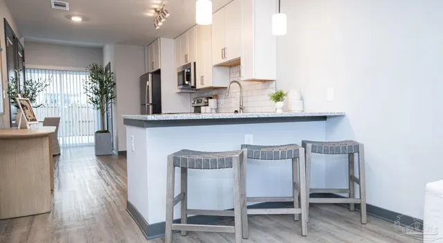 a dining room with furniture and wooden floor