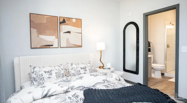 a bedroom with a large bed and a window