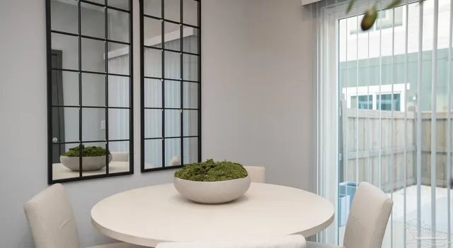 a view of a dining room with furniture and window