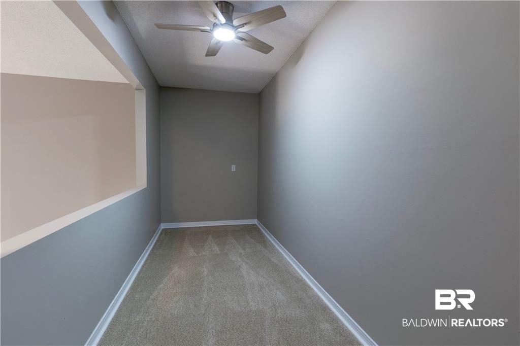 101 Lawson Road Daphne, AL 36526 - Photo 17 of 20 Carpeted room featuring a ceiling fan with integrated lighting, a wall niche, and baseboards