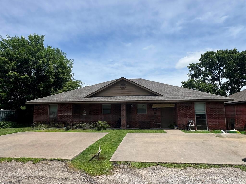 4515 Southeast Loop 286 Paris, TX 75460 - Photo 3 of 37 a front view of a house with a yard and garage