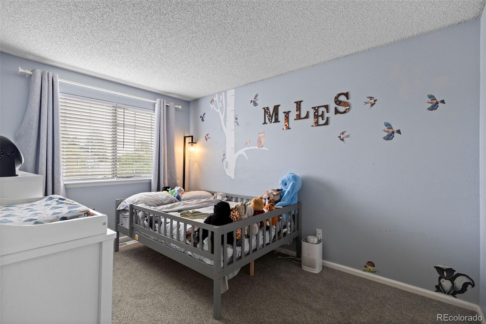 10565 Hyacinth Place Highlands Ranch, CO 80129 - Photo 24 of 33 a bedroom with a bed and a table