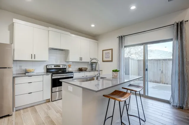 a kitchen with a table chairs and entryway