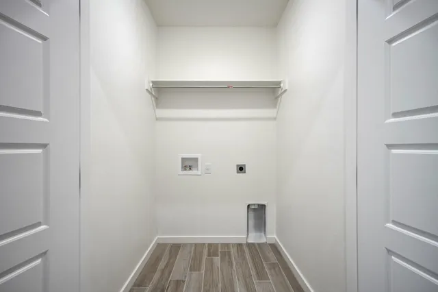 an empty room with a window and ceiling fan