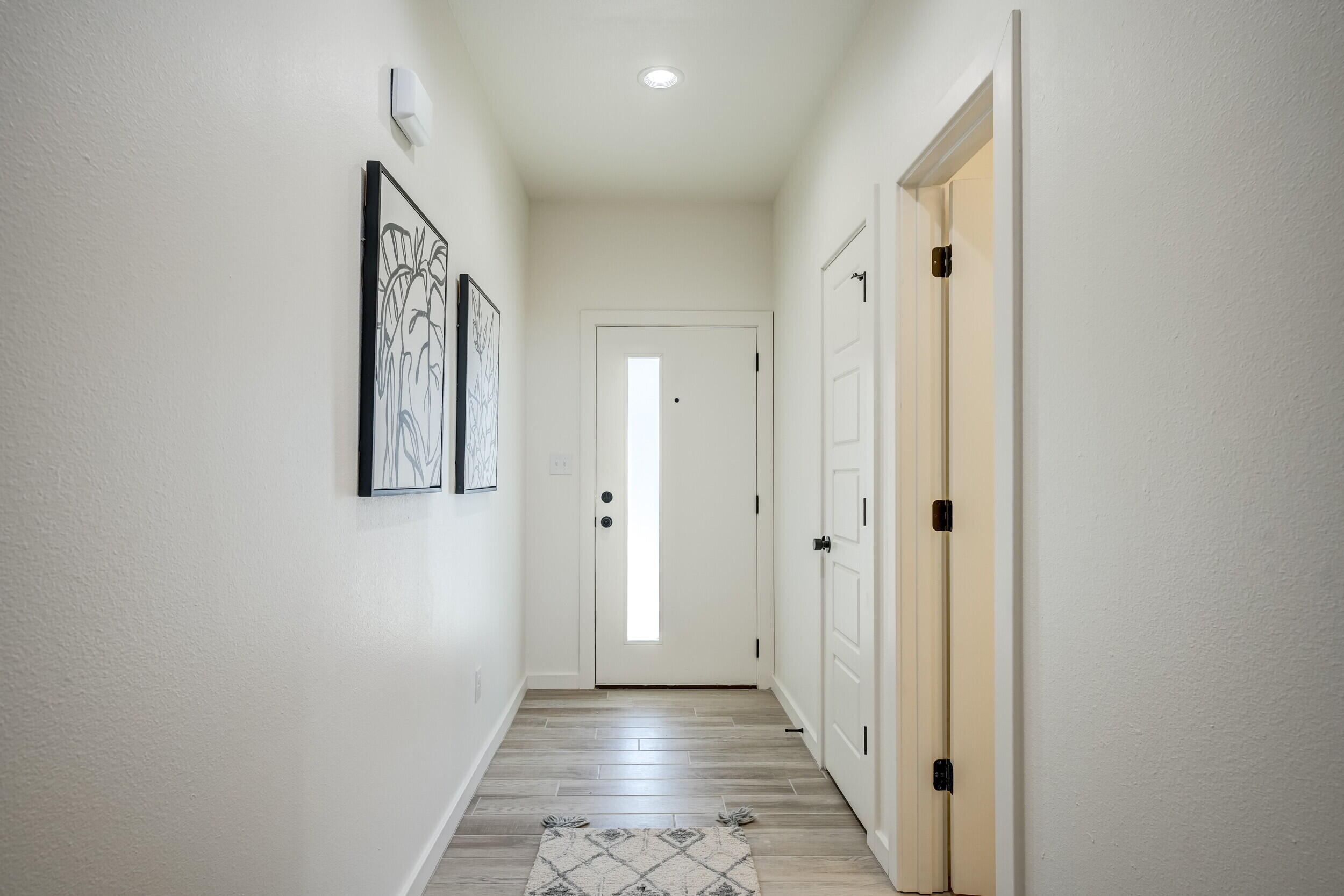 310 Homestead Avenue, Unit 16 Lubbock, TX 79416 - Photo 4 of 29 a view of a hallway with wooden floor