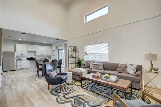 a living room with furniture and wooden floor