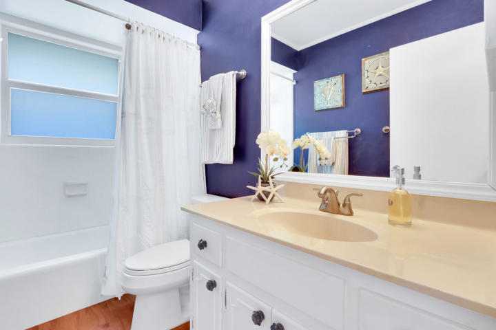 434 French Royale Circle Atlantis, FL 33462 - Photo 13 of 17 a bathroom with a granite countertop sink toilet and shower