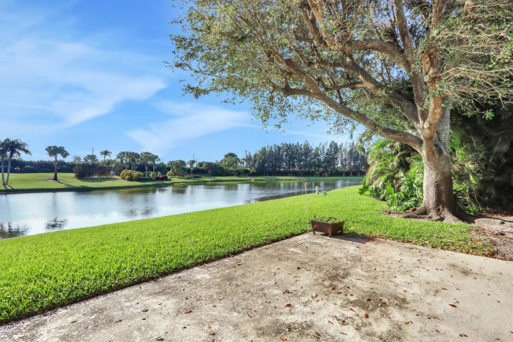 434 French Royale Circle Atlantis, FL 33462 - Photo 16 of 17 a view of a lake with a big yard