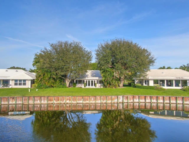 434 French Royale Circle Atlantis, FL 33462 - Photo 3 of 17 a front view of a residential apartment building with a yard