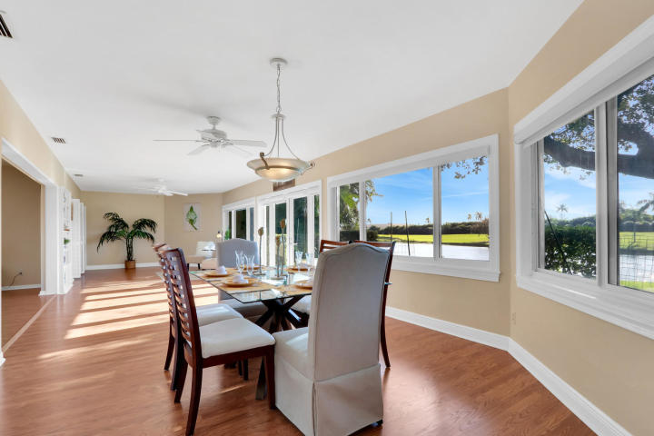 434 French Royale Circle Atlantis, FL 33462 - Photo 6 of 17 a view of a dining room with furniture window and wooden floor