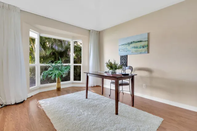a view of a livingroom with furniture window and wooden floor