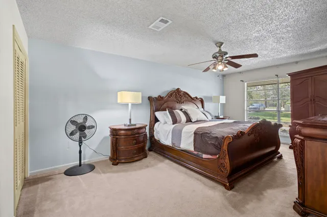 a bedroom with a bed and ceiling fan