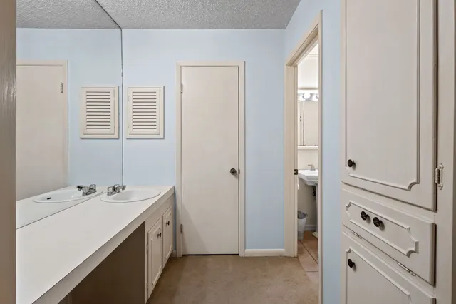 a bathroom with a sink a vanity and a mirror