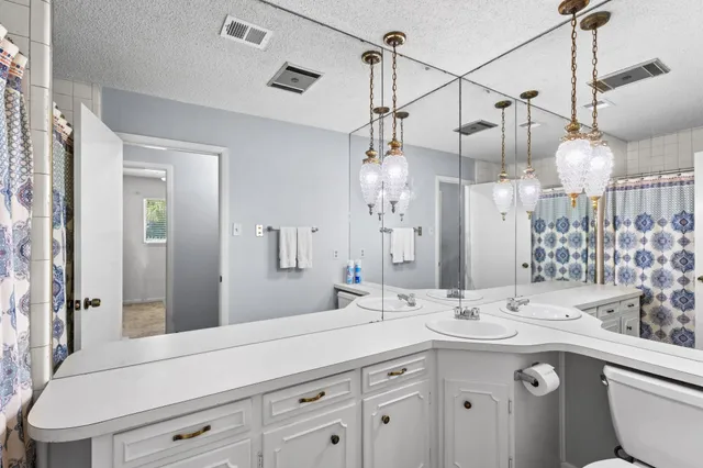 a bathroom with a sink vanity granite and a mirror