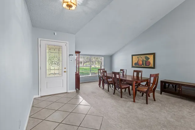 a dining room with furniture and a chandelier