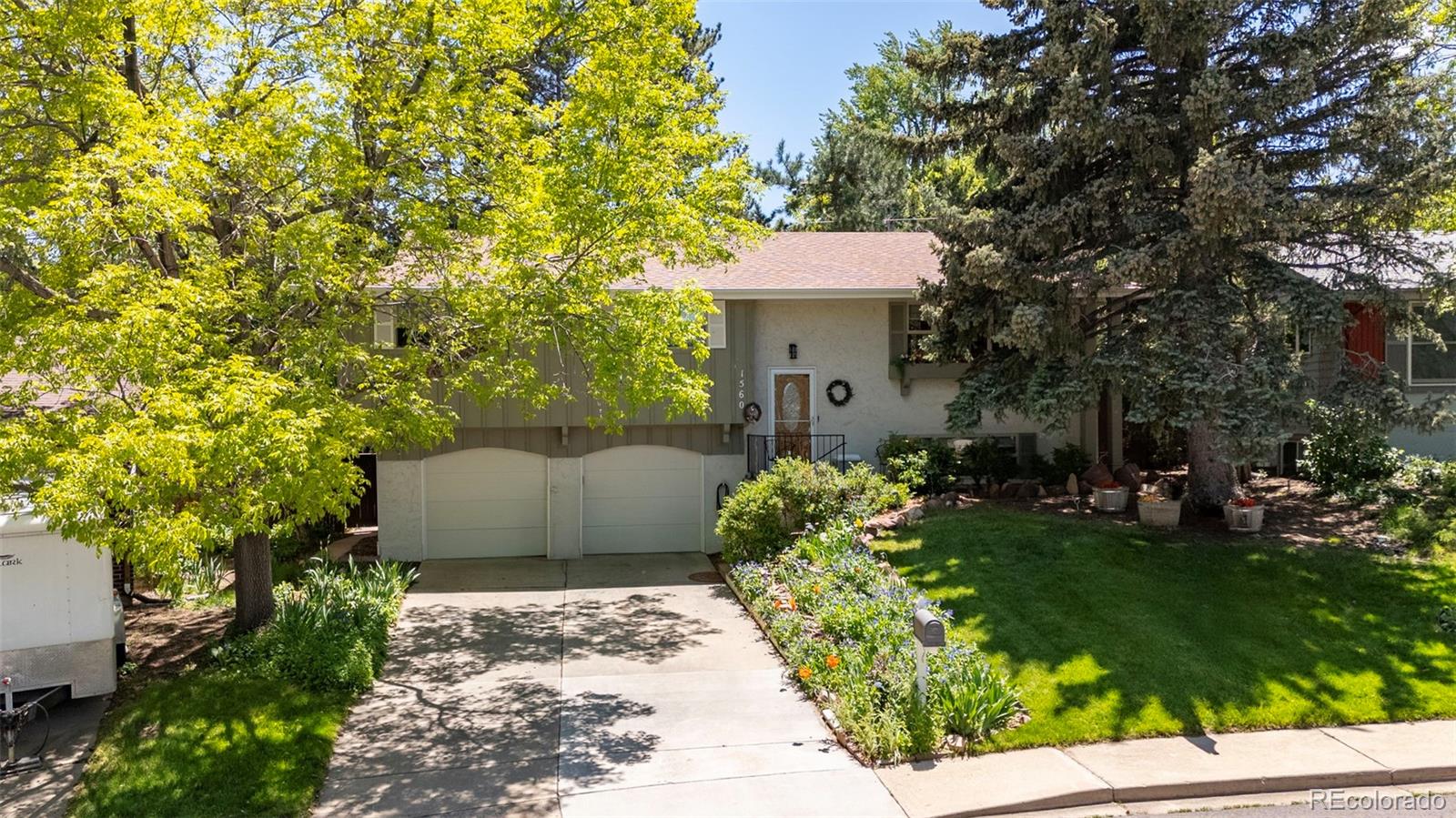 a view of a house with a yard and tree s