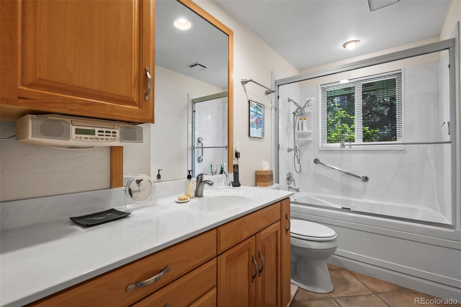 1560 Findlay Way Boulder, CO 80305 - Photo 13 of 40 a bathroom with a sink a toilet and shower
