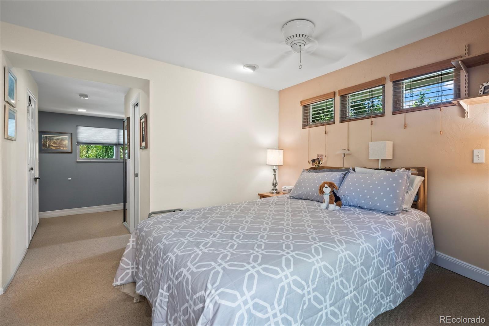 1560 Findlay Way Boulder, CO 80305 - Photo 15 of 40 a bedroom with a large bed and a chandelier