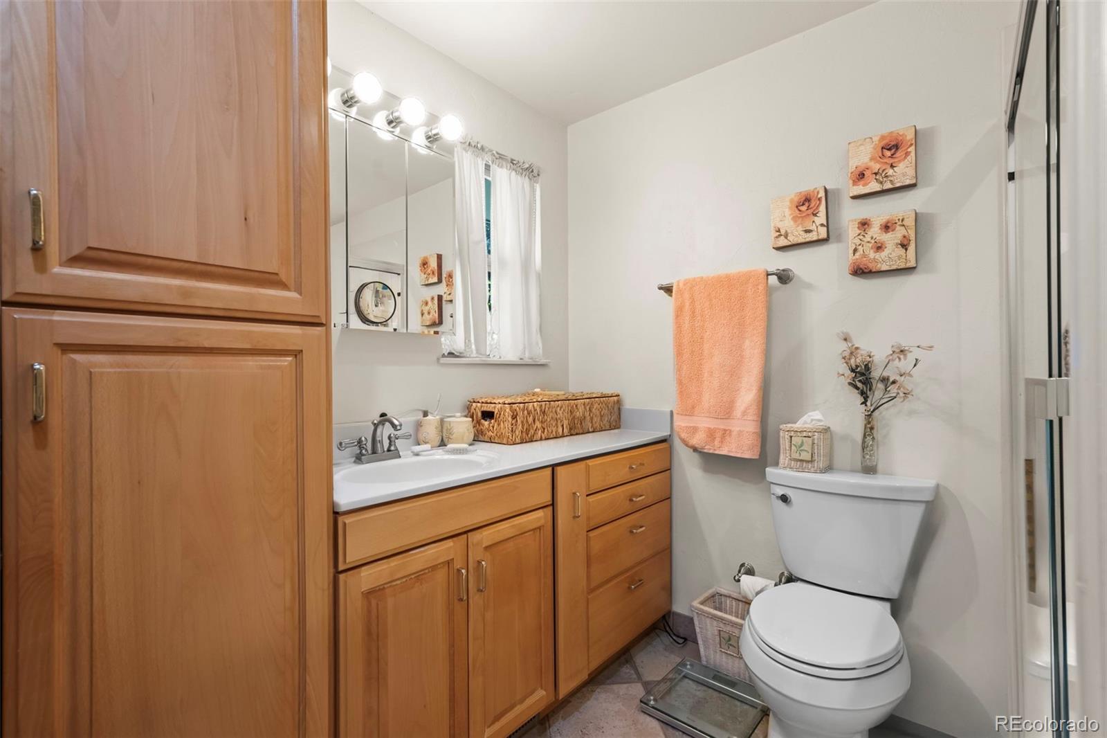 1560 Findlay Way Boulder, CO 80305 - Photo 18 of 40 a bathroom with a granite countertop toilet sink and mirror