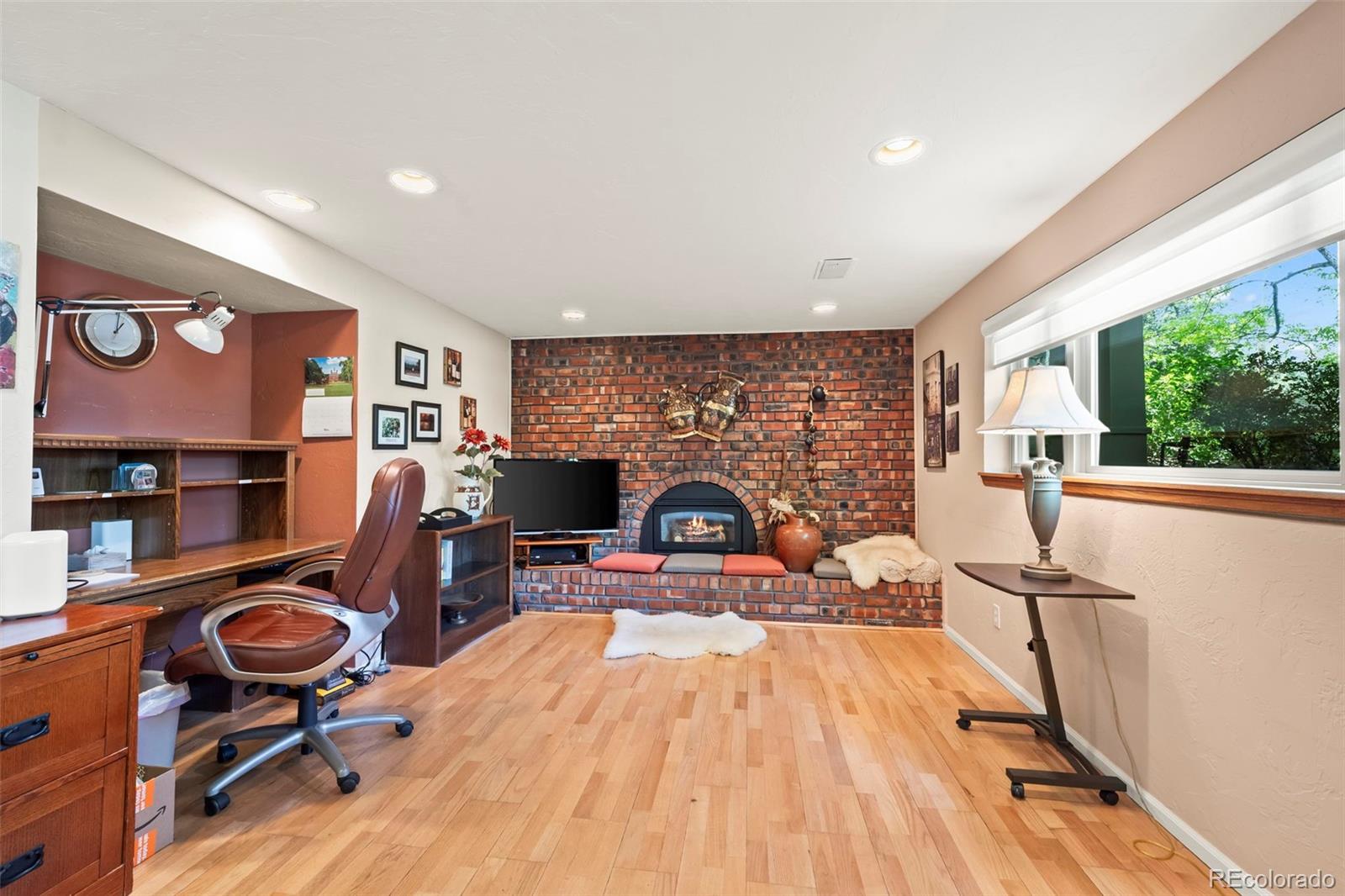 1560 Findlay Way Boulder, CO 80305 - Photo 20 of 40 a living room with furniture a rug and a fireplace