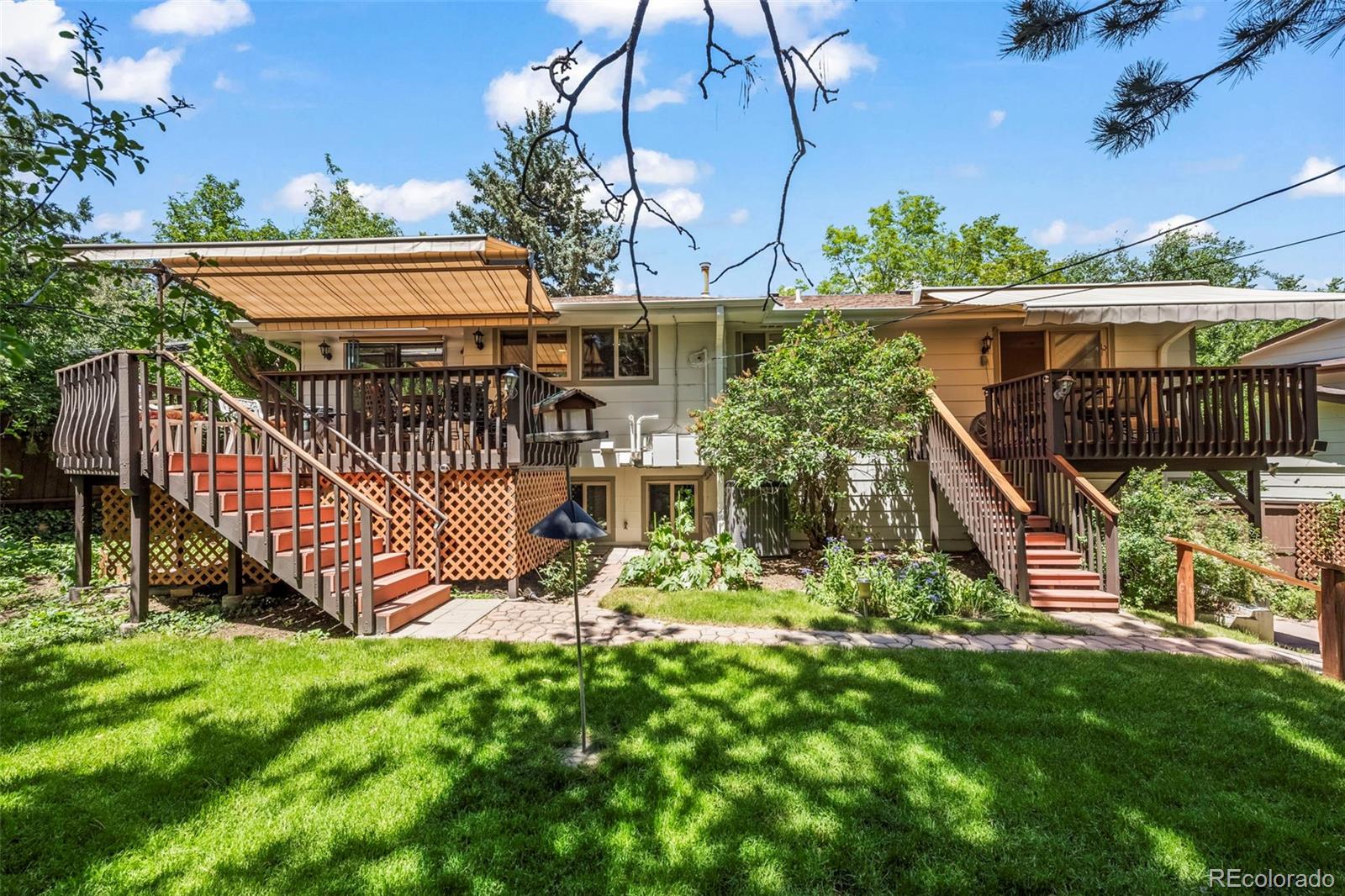 1560 Findlay Way Boulder, CO 80305 - Photo 31 of 40 a view of a house with a small yard and wooden fence