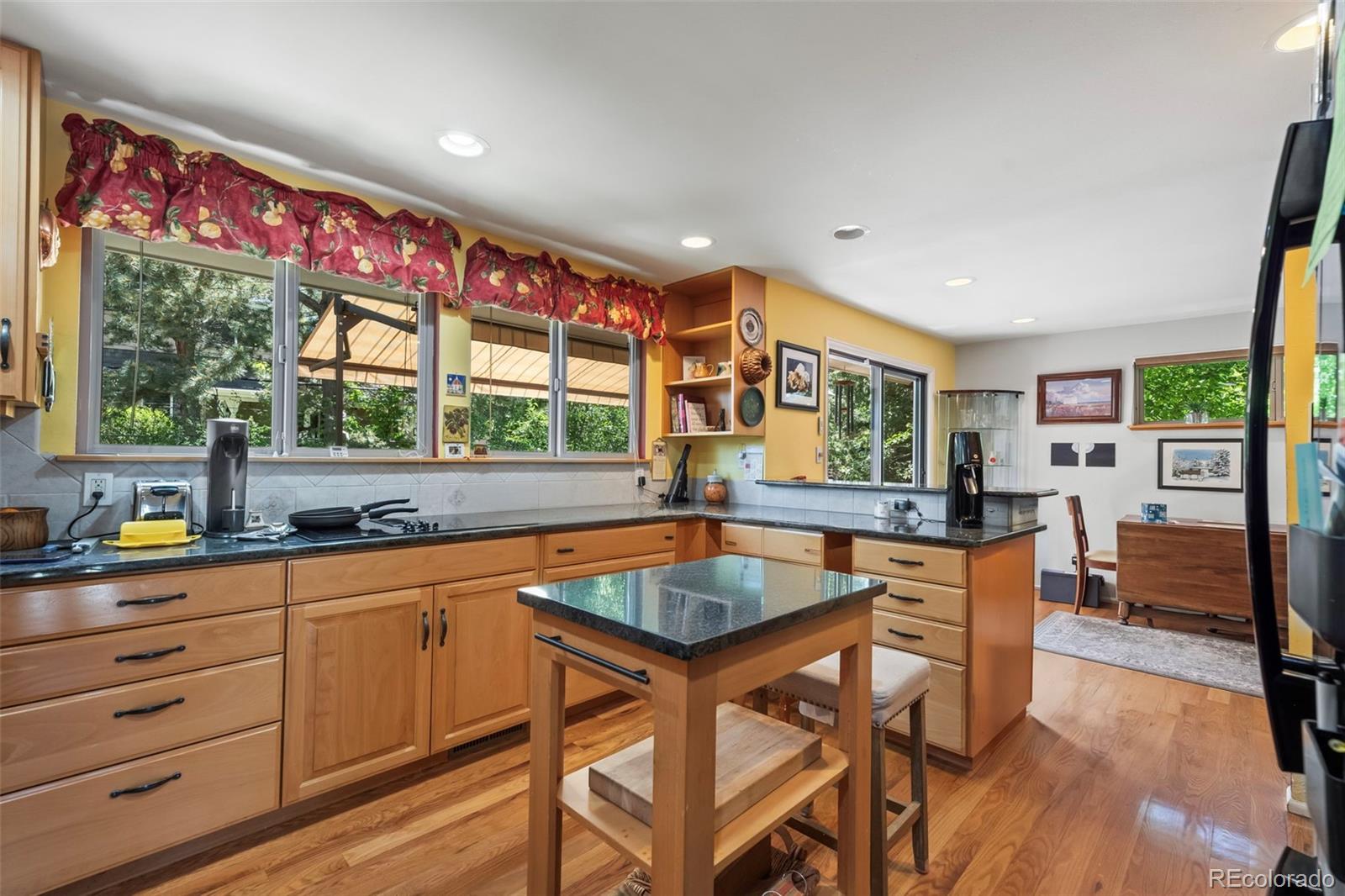1560 Findlay Way Boulder, CO 80305 - Photo 9 of 40 a kitchen with a table chairs sink and wooden floor