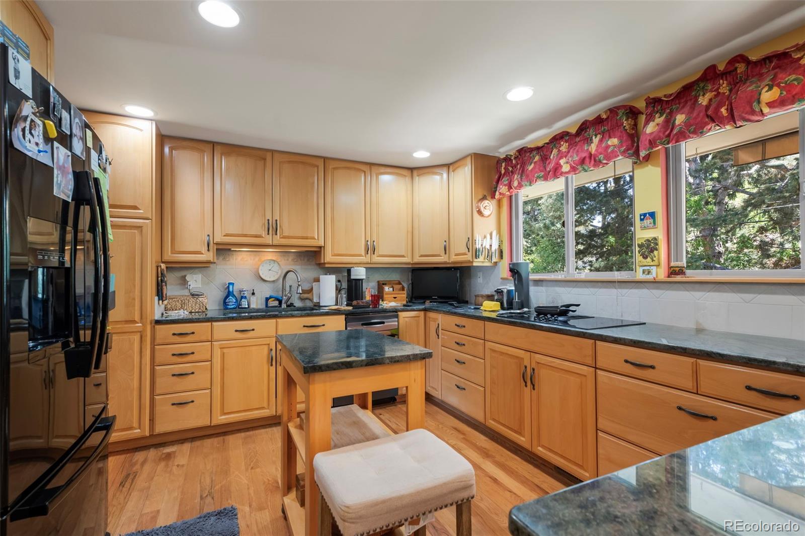 1560 Findlay Way Boulder, CO 80305 - Photo 10 of 40 a kitchen with granite countertop wooden cabinets and stainless steel appliances