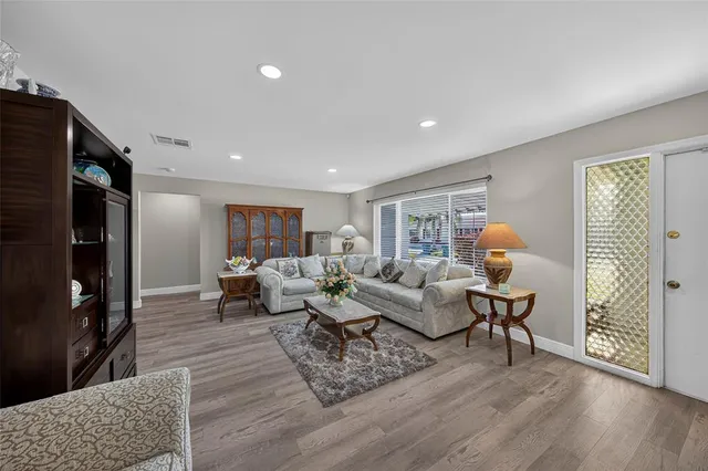 a living room with fireplace furniture and a wooden floor